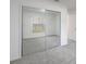 Bedroom showcasing mirrored closet doors and neutral colored walls at 5990 Se 5Th Pl, Ocala, FL 34472
