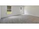 Bedroom with carpeting, white walls, and two windows providing natural light at 5990 Se 5Th Pl, Ocala, FL 34472