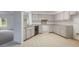 Clean kitchen with ample counter space, white cabinetry, and stainless steel appliances at 5990 Se 5Th Pl, Ocala, FL 34472