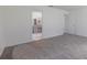 Main bedroom with neutral carpet and an open view into the ensuite bathroom at 5990 Se 5Th Pl, Ocala, FL 34472