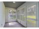 Enclosed sunroom with multiple windows allowing natural light and views of the backyard at 5990 Se 5Th Pl, Ocala, FL 34472