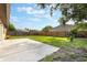 Expansive backyard boasts a concrete patio, lush lawn, and a wooden privacy fence at 6835 Massa Ct, Orlando, FL 32810