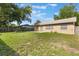 Wide backyard view, featuring a well-maintained lawn, privacy fence, and a cozy patio at 6835 Massa Ct, Orlando, FL 32810