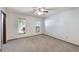 Spacious bedroom with neutral carpeting, multiple windows, and ample natural light at 6835 Massa Ct, Orlando, FL 32810
