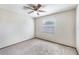 Cozy bedroom with neutral carpeting, a ceiling fan, and a window bringing in natural light at 6835 Massa Ct, Orlando, FL 32810