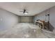 Spacious garage features a ceiling fan, concrete floor, and a workspace with a workbench at 6835 Massa Ct, Orlando, FL 32810