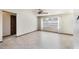 Bright living room featuring neutral walls, tile flooring, and a large window at 6835 Massa Ct, Orlando, FL 32810