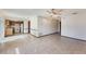 Spacious open-plan living room and kitchen with tile flooring and a ceiling fan at 6835 Massa Ct, Orlando, FL 32810
