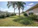 The home has a lush backyard featuring green grass and various palms and shrubbery at 710 Independence Dr, Orange City, FL 32763
