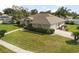 Well-kept home featuring a lush lawn and mature greenery at 710 Independence Dr, Orange City, FL 32763