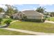 Charming single-story home with a well-manicured lawn and mature landscaping at 710 Independence Dr, Orange City, FL 32763