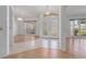 Open foyer with ceramic tile and hardwood flooring and view to the front entrance at 710 Independence Dr, Orange City, FL 32763