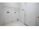 Simple laundry room featuring wire shelving, clean white walls, and a utility door at 710 Independence Dr, Orange City, FL 32763