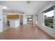 Spacious living room with laminate floors, natural light, and seamless flow to the kitchen and outdoor areas at 710 Independence Dr, Orange City, FL 32763