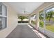 Covered patio with screen windows, ceiling fan, and view of landscaped backyard at 710 Independence Dr, Orange City, FL 32763