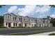 Charming new townhomes with a sidewalk and well-maintained landscaping for a welcoming curb appeal at 7358 Ivy Tendril Ave, Orlando, FL 32829