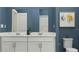 Modern bathroom features double sinks, white cabinets, and a clean design at 7374 Ivy Tendril Ave, Orlando, FL 32829