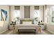 Inviting bedroom features a cozy bed with decorative pillows, side tables with lamps, and a stylish rug at 7374 Ivy Tendril Ave, Orlando, FL 32829