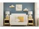 Charming Bedroom featuring a white crib, cloud accents, and soft lighting at 7374 Ivy Tendril Ave, Orlando, FL 32829