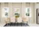 Elegant dining room with a modern table setting and lots of natural light at 7374 Ivy Tendril Ave, Orlando, FL 32829