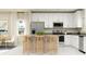 Modern kitchen boasts stainless steel appliances, white cabinets, and a breakfast bar at 7374 Ivy Tendril Ave, Orlando, FL 32829