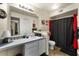 Practical bathroom featuring a vanity with ample counter space, a sink, and a shower with a red curtain at 829 Camargo Way # 211, Altamonte Springs, FL 32714