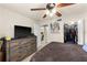 Spacious bedroom featuring a rustic dresser, ceiling fan, and a convenient walk-in closet at 829 Camargo Way # 211, Altamonte Springs, FL 32714