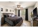 Comfortable bedroom with a dark wood bed frame, natural light from the window, and a ceiling fan at 829 Camargo Way # 211, Altamonte Springs, FL 32714
