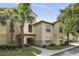 Inviting condo building featuring lush landscaping and a well-maintained exterior with beautiful palm trees at 829 Camargo Way # 211, Altamonte Springs, FL 32714