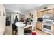 Functional kitchen with a breakfast bar, white appliances, and a view into the living area at 829 Camargo Way # 211, Altamonte Springs, FL 32714