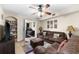 Cozy living room featuring a comfortable brown sofa, ceiling fan, and seamless access to the bedroom at 829 Camargo Way # 211, Altamonte Springs, FL 32714