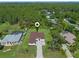 An aerial view of a single-Gathering home with a large, landscaped yard and a paved driveway at 10 Dial Ave, Debary, FL 32713