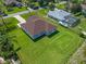 Aerial view showcases backyard with lush lawn and a boat parked next to the neighboring pool at 10 Dial Ave, Debary, FL 32713
