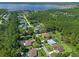 The aerial showcases a community with mature trees and houses situated along a lake at 10 Dial Ave, Debary, FL 32713