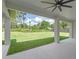 Spacious covered patio overlooking a large, well-maintained backyard with lush landscaping at 10 Dial Ave, Debary, FL 32713