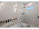 Elegant bathroom featuring marble tile, granite vanity, and glass-enclosed walk-in shower at 10 Dial Ave, Debary, FL 32713
