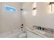 This elegant bathroom features a bathtub and a granite-topped sink with black fixtures at 10 Dial Ave, Debary, FL 32713