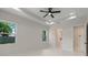 Spacious bedroom showcases a modern ceiling fan and serene views from its large windows at 10 Dial Ave, Debary, FL 32713