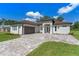 Exterior elevation showcasing the home's facade, driveway, and landscaping on a sunny day at 10 Dial Ave, Debary, FL 32713