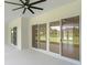 Covered patio with sliding glass doors offering a view of the expansive backyard at 10 Dial Ave, Debary, FL 32713