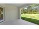 Outdoor patio with a view of the expansive, green backyard and mature trees at 10 Dial Ave, Debary, FL 32713