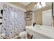 This bathroom features a seashell-themed shower curtain, a light fixture, and plenty of space to get ready at 1090 Sonoma Ct, Longwood, FL 32750