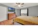 Well-lit bedroom with wood floors, a mounted TV, and ample closet space at 1090 Sonoma Ct, Longwood, FL 32750