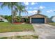 Single-story home with tropical landscaping, manicured lawn, and a two-car garage at 1090 Sonoma Ct, Longwood, FL 32750