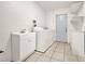 This laundry room features a washer and dryer, a sink, and plenty of cabinet space for storage at 1090 Sonoma Ct, Longwood, FL 32750