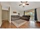 Inviting living room with sliding glass doors to lanai, with ceiling fan and wood flooring throughout at 1090 Sonoma Ct, Longwood, FL 32750