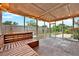 Screened patio area with a view of fenced in backyard, wooden bench and string lights at 1090 Sonoma Ct, Longwood, FL 32750
