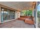 The screened-in patio offers a comfortable seating area with wood furniture, perfect for enjoying the outdoors at 1090 Sonoma Ct, Longwood, FL 32750