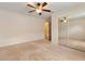 Bedroom featuring a ceiling fan and mirrored closet doors at 1154 Feather Dr, Deltona, FL 32725
