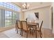 Bright dining room with a large window, a modern chandelier, and a wooden dining set for six at 1154 Feather Dr, Deltona, FL 32725